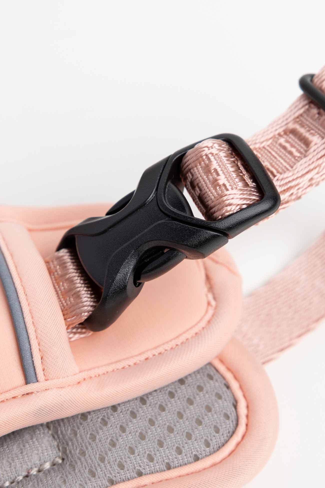 Blush pink dog harness up-close with the traditional black buckle.