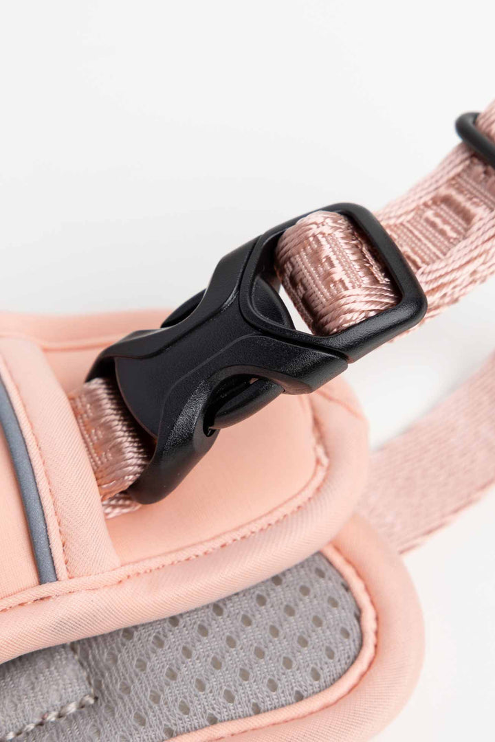 Blush pink dog harness up-close with the traditional black buckle.