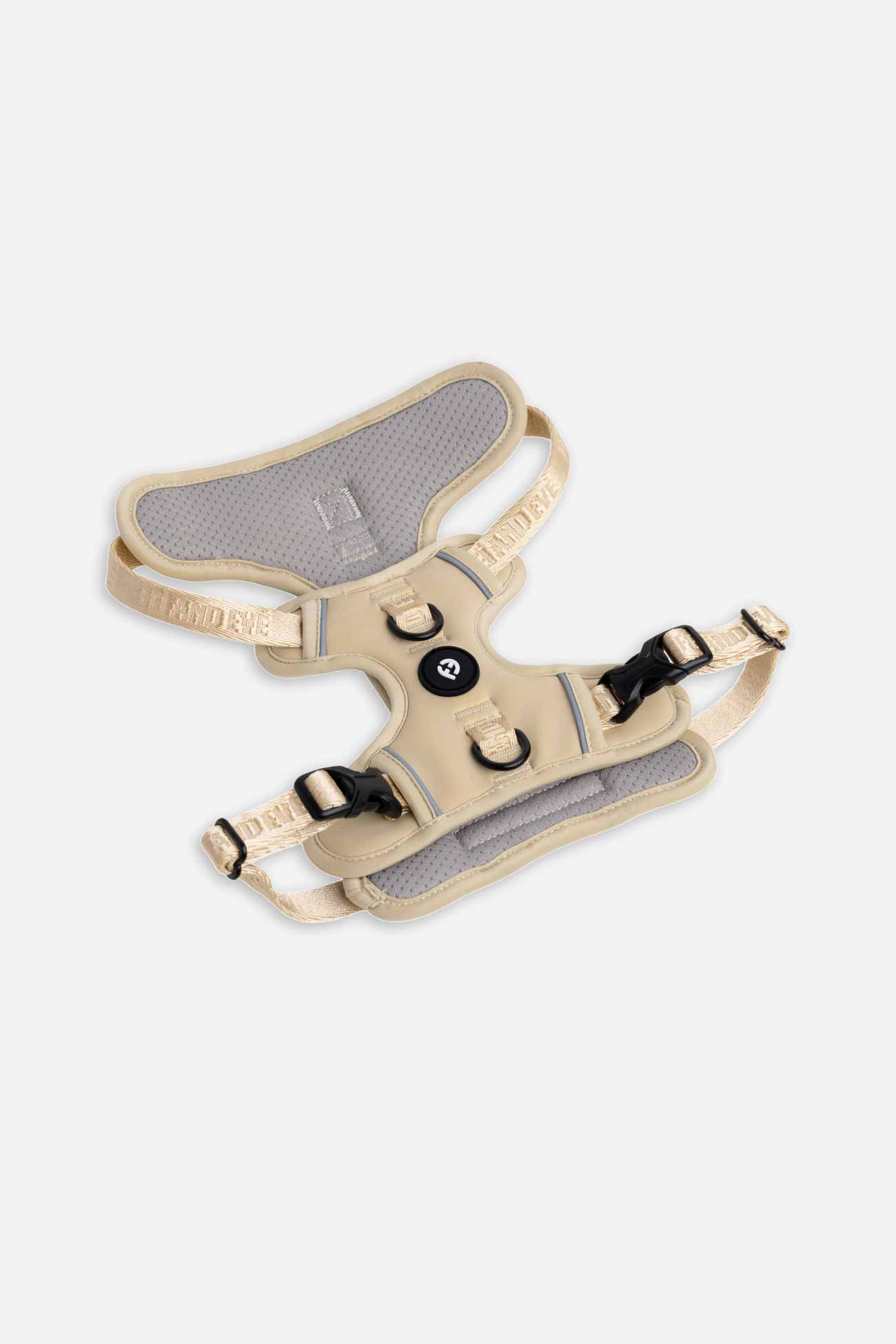 Champagne Cloud Harness with Traditional Buckles laying flat on white floor