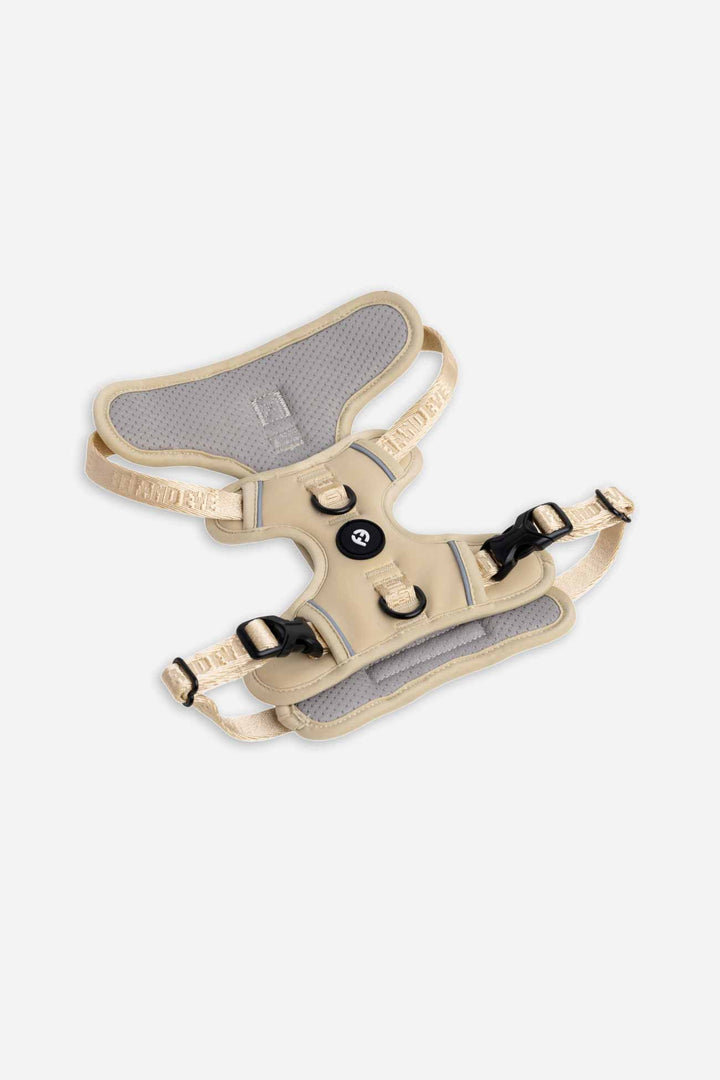 Champagne Cloud Harness with Traditional Buckles laying flat on white floor