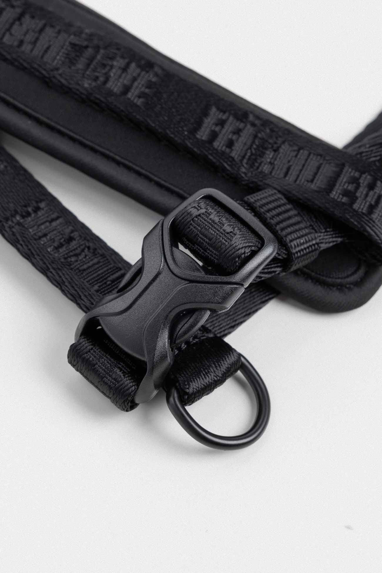 Black Moxie Harness with Traditional Buckles close-up of beige dog strap with black buckle and leash ring
