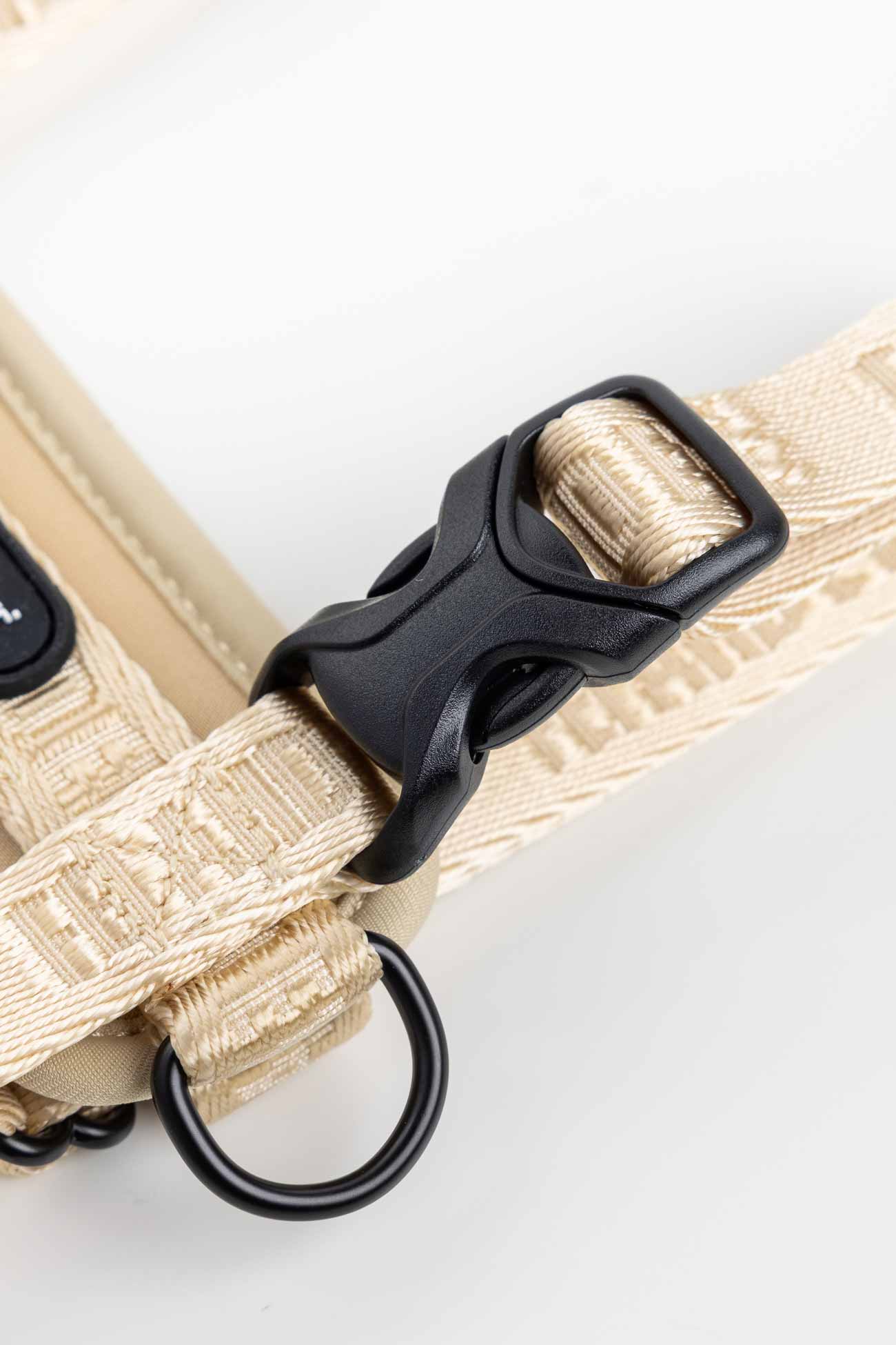 Champagne Moxie Harness with Traditional Buckles close-up of beige dog strap with black buckle and leash ring